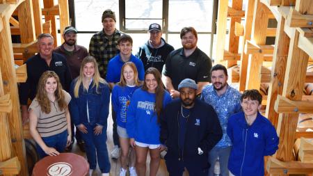 The Beam Institute's inaugural Commercialization of Distilled Spirits course students pose for a group photo with honorary professor Herb Heneman in JBBI's on-site barrel house. Photo courtesy of Herb Heneman.